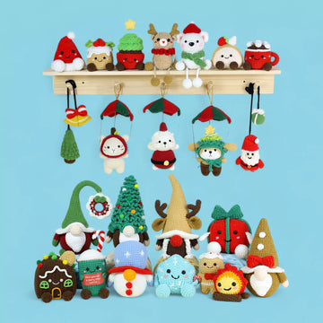 Collection of crochet Christmas ornaments, dolls, santa, navity scene, applique, christmas tree,gift crochet on a blue background in Hooktasy
