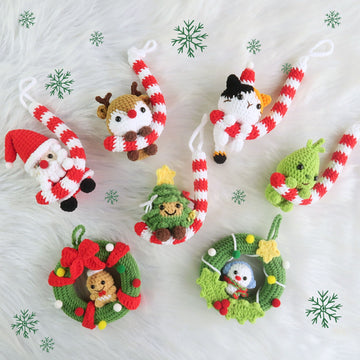 Set of crocheted Christmas ornaments on a white background with snowflake decorations.