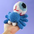 Eyes Ball Spider Crochet Pattern on a purple background
