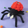 Eyes Rose Halloween Spider Crochet Pattern on the purple background in Hooktasy